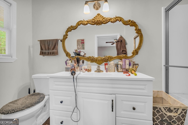 bathroom featuring vanity and toilet