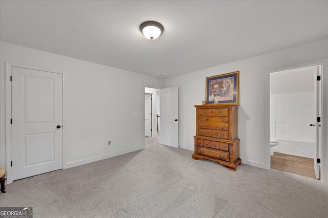 carpeted bedroom with ensuite bathroom