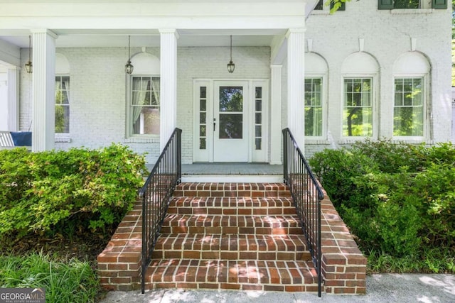 view of exterior entry with a porch