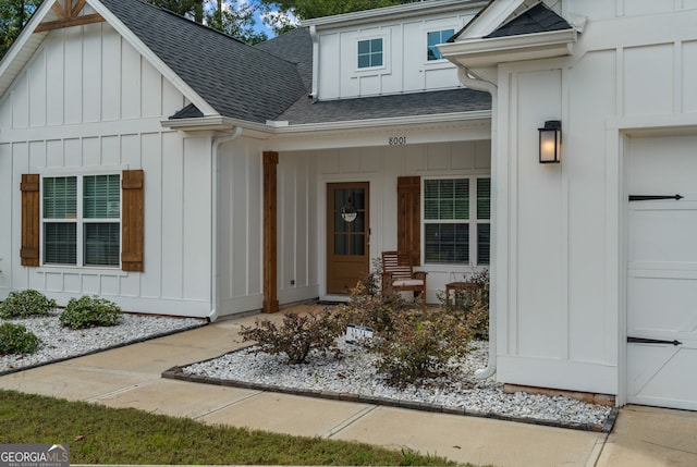 doorway to property with a garage and a porch