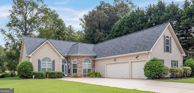 view of front of home with a front lawn and a garage