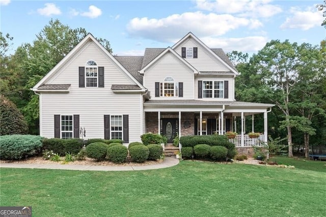 view of front of house with a porch and a front yard