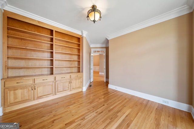 unfurnished living room featuring light wood-type flooring and ornamental molding