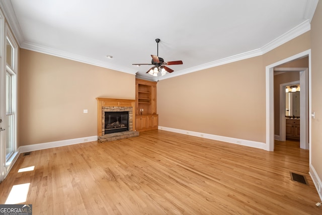 unfurnished living room with ceiling fan, crown molding, and light hardwood / wood-style floors