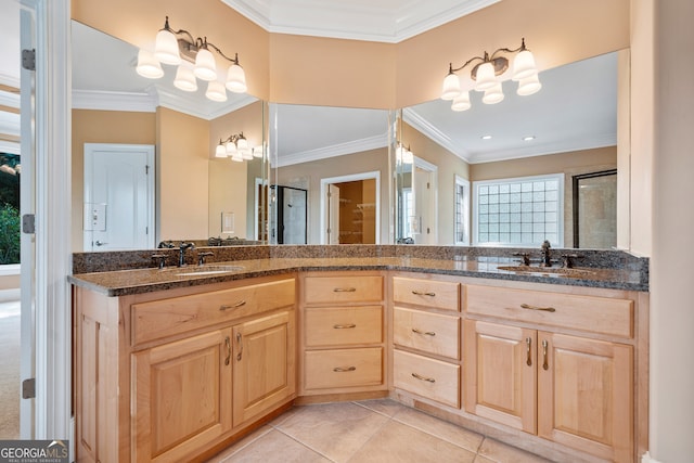 bathroom with tile patterned floors, a shower with door, vanity, and crown molding