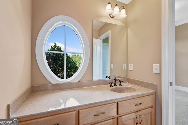 bathroom with ornamental molding and vanity