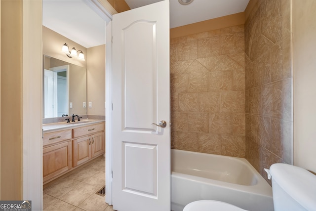 full bathroom with tile patterned flooring, tiled shower / bath, vanity, and toilet