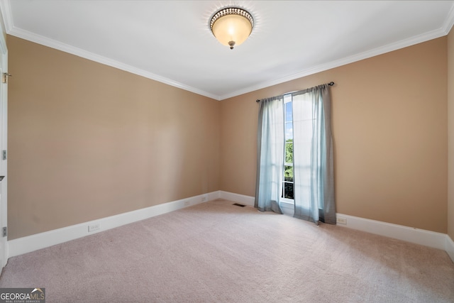 unfurnished room with ornamental molding and light colored carpet