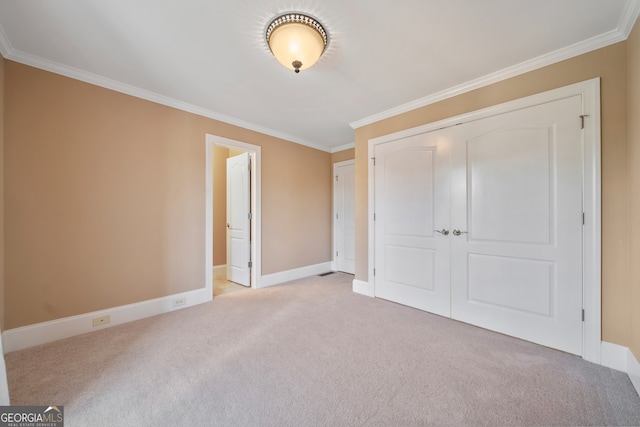 unfurnished bedroom featuring light carpet, connected bathroom, a closet, and crown molding