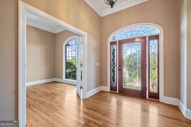 foyer entrance featuring light hardwood / wood-style floors and ornamental molding