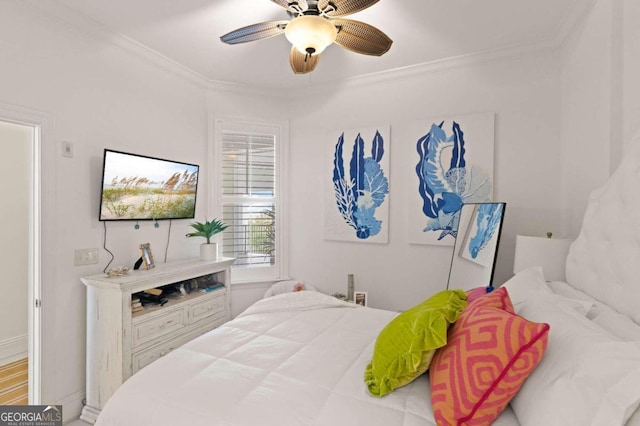 bedroom featuring crown molding, ceiling fan, and hardwood / wood-style flooring