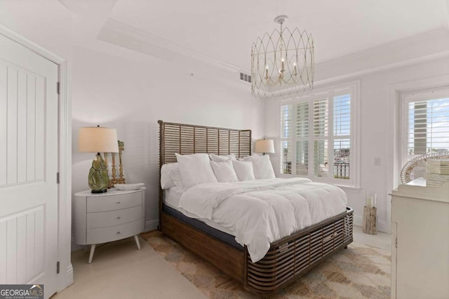 bedroom with a notable chandelier, light colored carpet, and ornamental molding