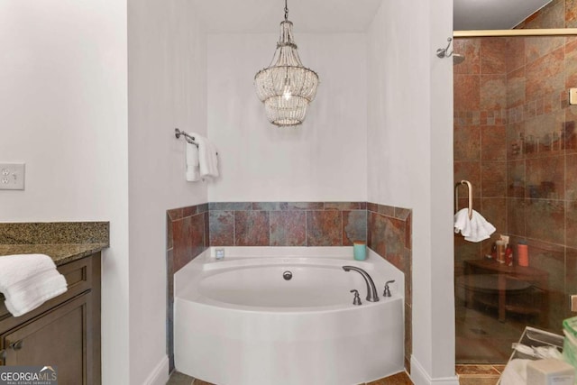 bathroom featuring independent shower and bath, vanity, and a notable chandelier