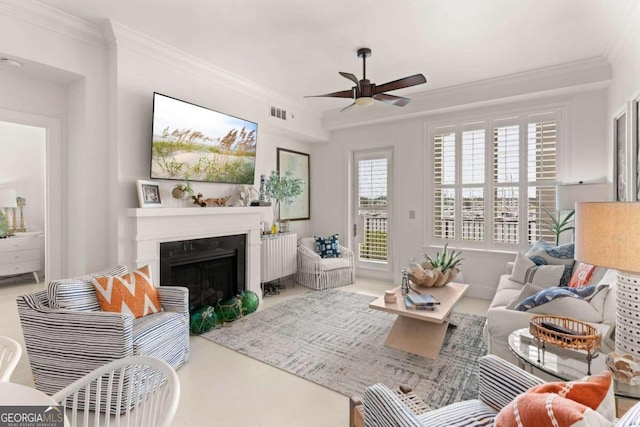 living room with ornamental molding and ceiling fan