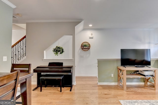 interior space with light hardwood / wood-style floors and crown molding