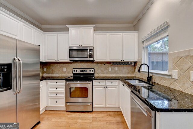 kitchen featuring white cabinets, light hardwood / wood-style floors, and appliances with stainless steel finishes