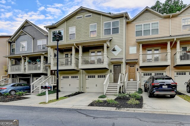 townhome / multi-family property with a porch and a garage