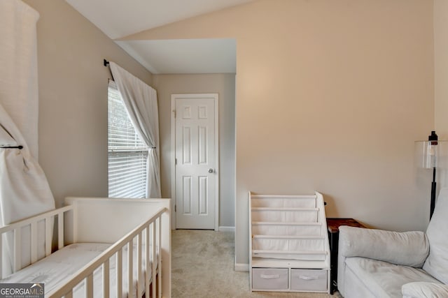 bedroom with light carpet and lofted ceiling