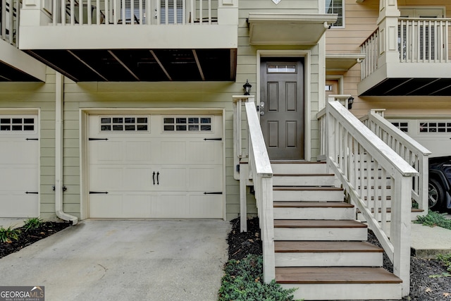 doorway to property with a balcony and a garage