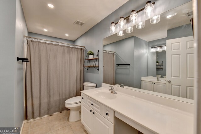 bathroom with walk in shower, vanity, toilet, and tile patterned floors