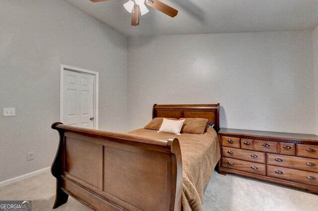 bedroom featuring lofted ceiling, light carpet, and ceiling fan