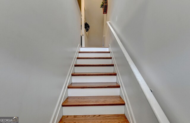 stairway featuring hardwood / wood-style flooring