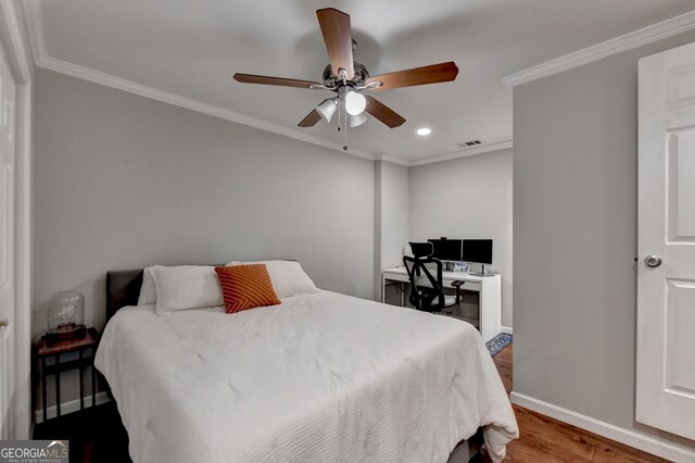 bedroom with ornamental molding, ceiling fan, and hardwood / wood-style flooring