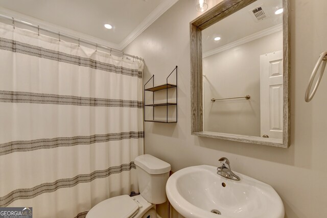 bathroom featuring ornamental molding, sink, toilet, and a shower with shower curtain