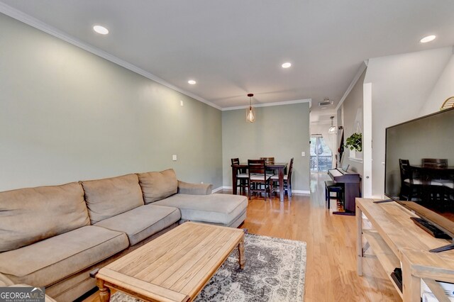 living room featuring light hardwood / wood-style flooring and ornamental molding