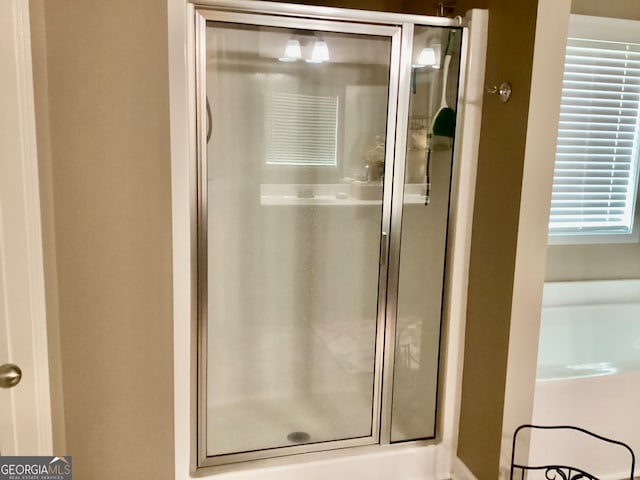 bathroom featuring a shower with shower door