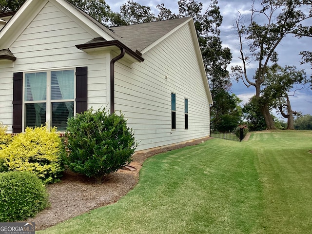 view of property exterior with a lawn