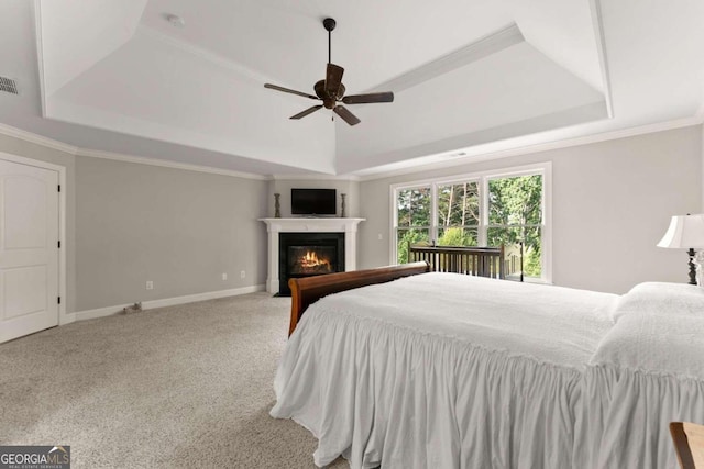 bedroom featuring carpet flooring, a raised ceiling, ceiling fan, and crown molding