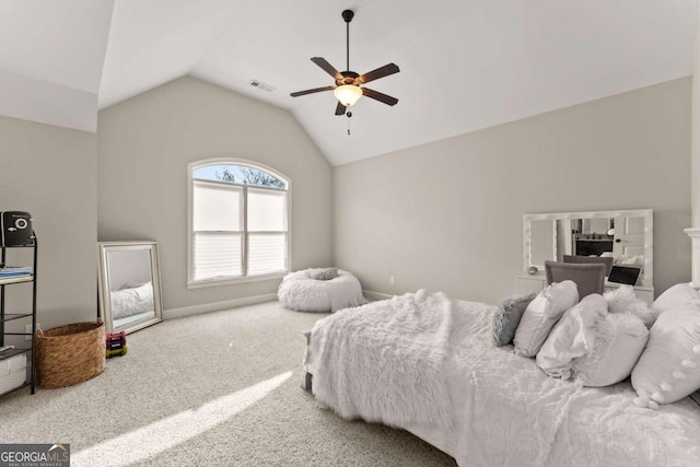 carpeted bedroom with ceiling fan and vaulted ceiling