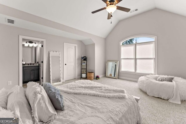 bedroom featuring carpet, vaulted ceiling, ensuite bath, and ceiling fan