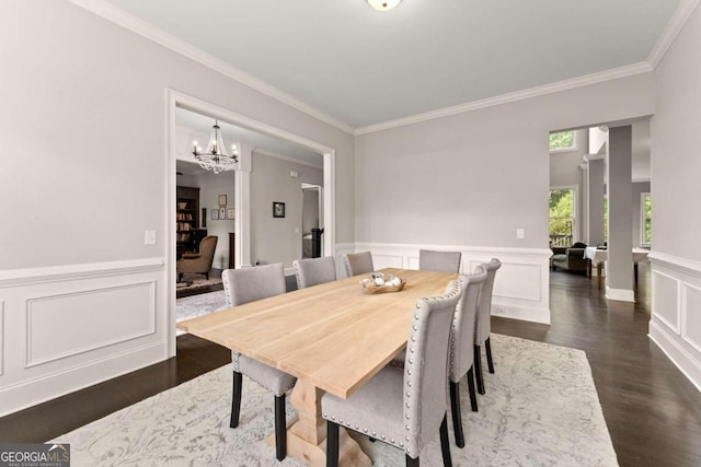 dining space with a notable chandelier, dark hardwood / wood-style floors, and ornamental molding