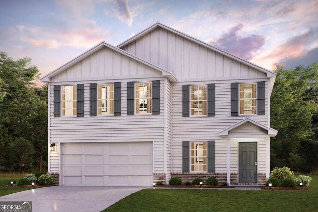 view of front of property featuring a lawn and a garage