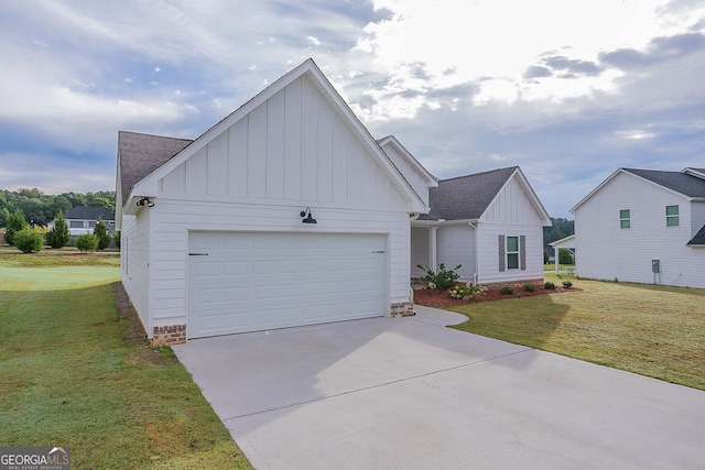 view of front of home with a front yard and a garage