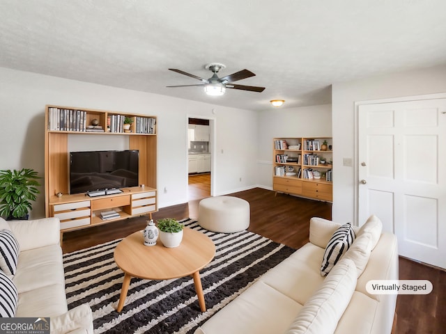 living room featuring ceiling fan and wood-type flooring