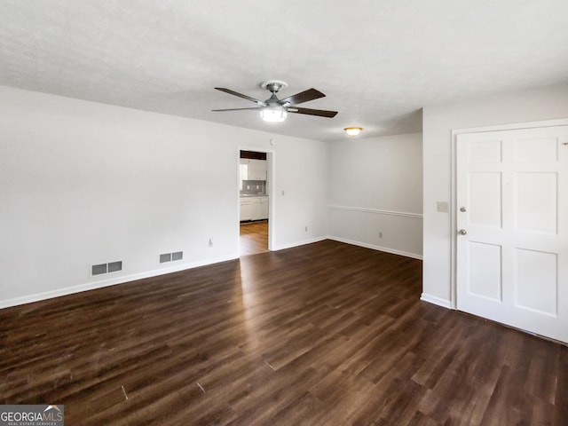 unfurnished room with ceiling fan and dark hardwood / wood-style flooring