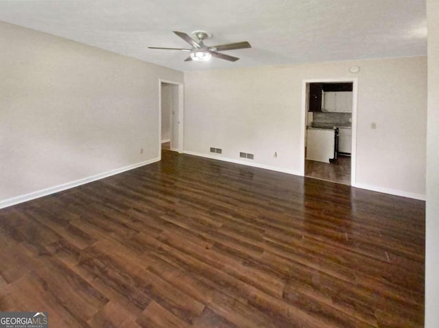 spare room with a textured ceiling, dark hardwood / wood-style flooring, and ceiling fan