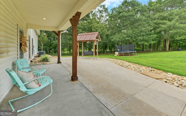 view of patio with a trampoline and central AC