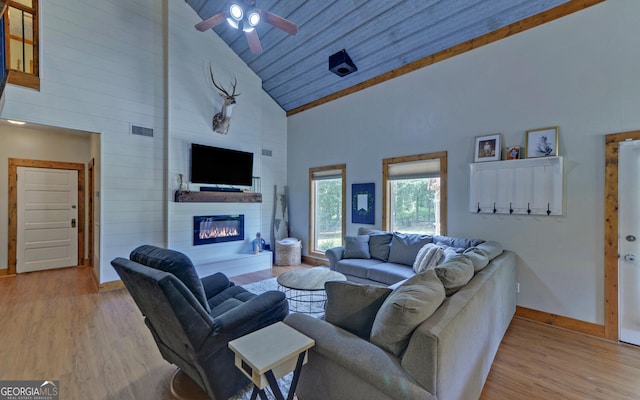 living room with light wood-type flooring, wood ceiling, ceiling fan, high vaulted ceiling, and a fireplace