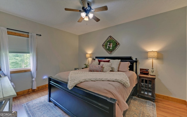 bedroom with ceiling fan and light hardwood / wood-style flooring