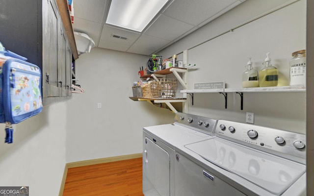 washroom featuring separate washer and dryer and light hardwood / wood-style flooring