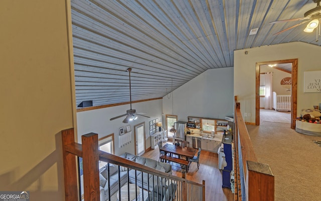 hall featuring wooden ceiling, a wealth of natural light, and lofted ceiling