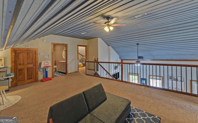 interior space with carpet floors, vaulted ceiling, and ceiling fan