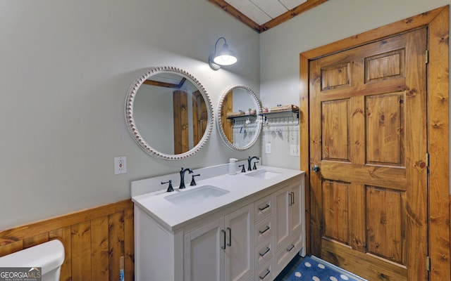 bathroom with vanity and wooden walls