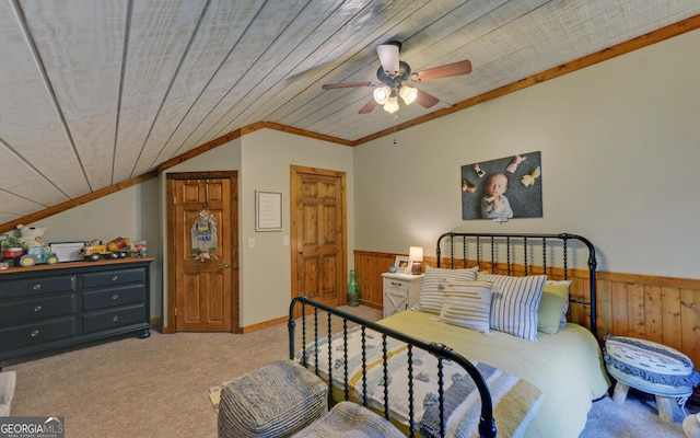 carpeted bedroom featuring wood walls, ceiling fan, wooden ceiling, and lofted ceiling