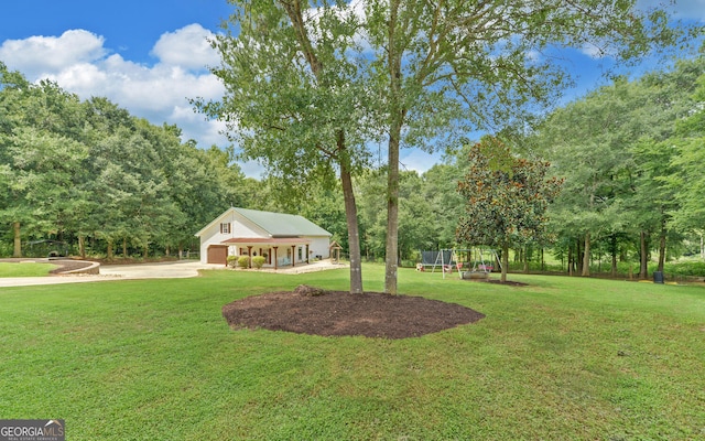 view of front of house with a front yard and a trampoline