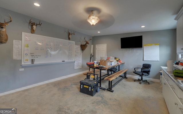 office space with ceiling fan and light carpet